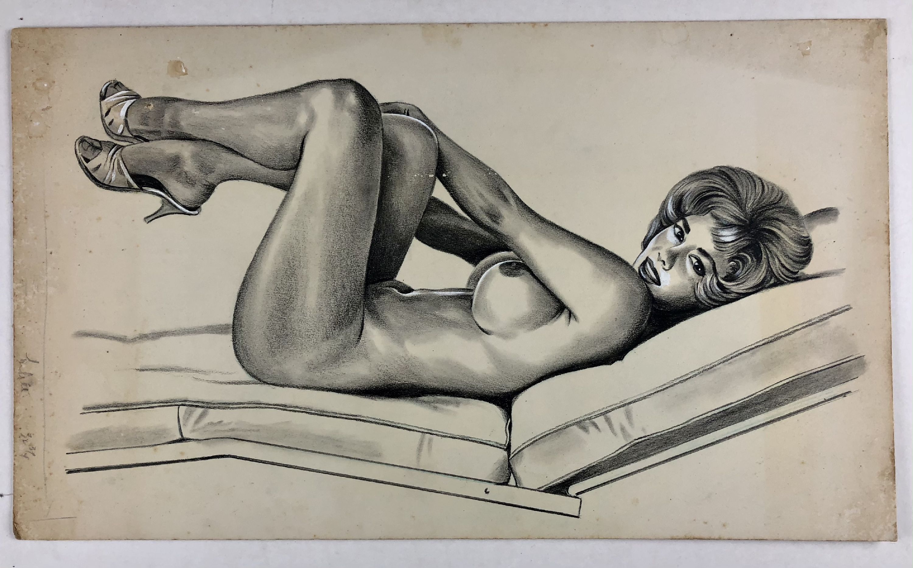 nude lying on chaise with arms and legs elevated