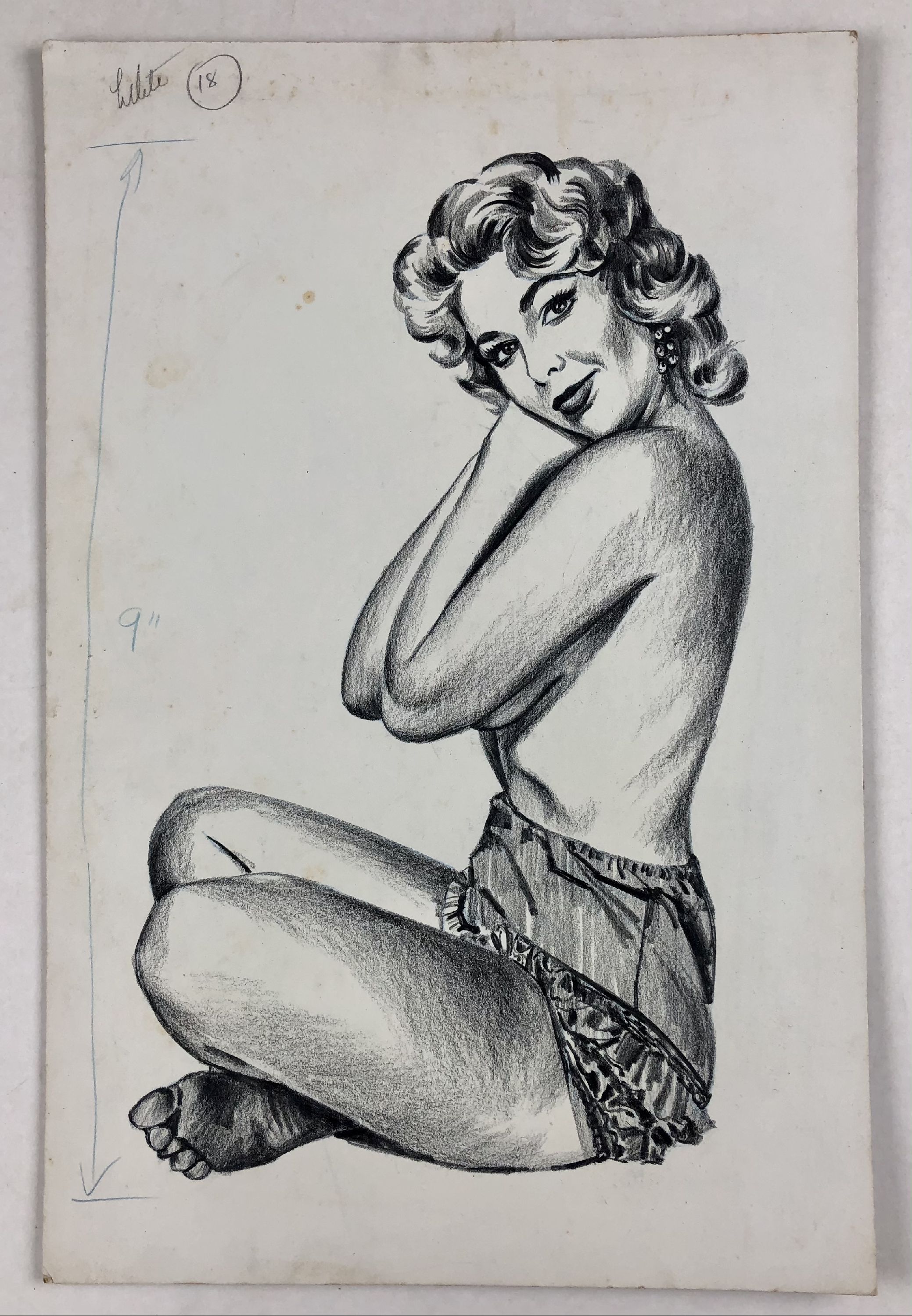 topless woman sitting cross-legged in ruffled lingerie 