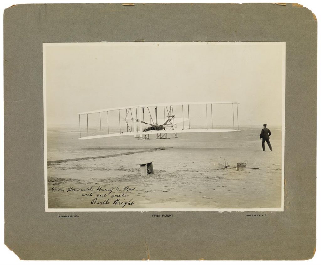 Lot 96, a photograph signed by Orville Wright showing the first flight of the Wright Flyer.