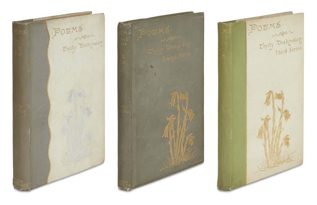 Emily Dickinson's first three books of poetry showing the covers of each one white and gray, one gray, and one green and white.