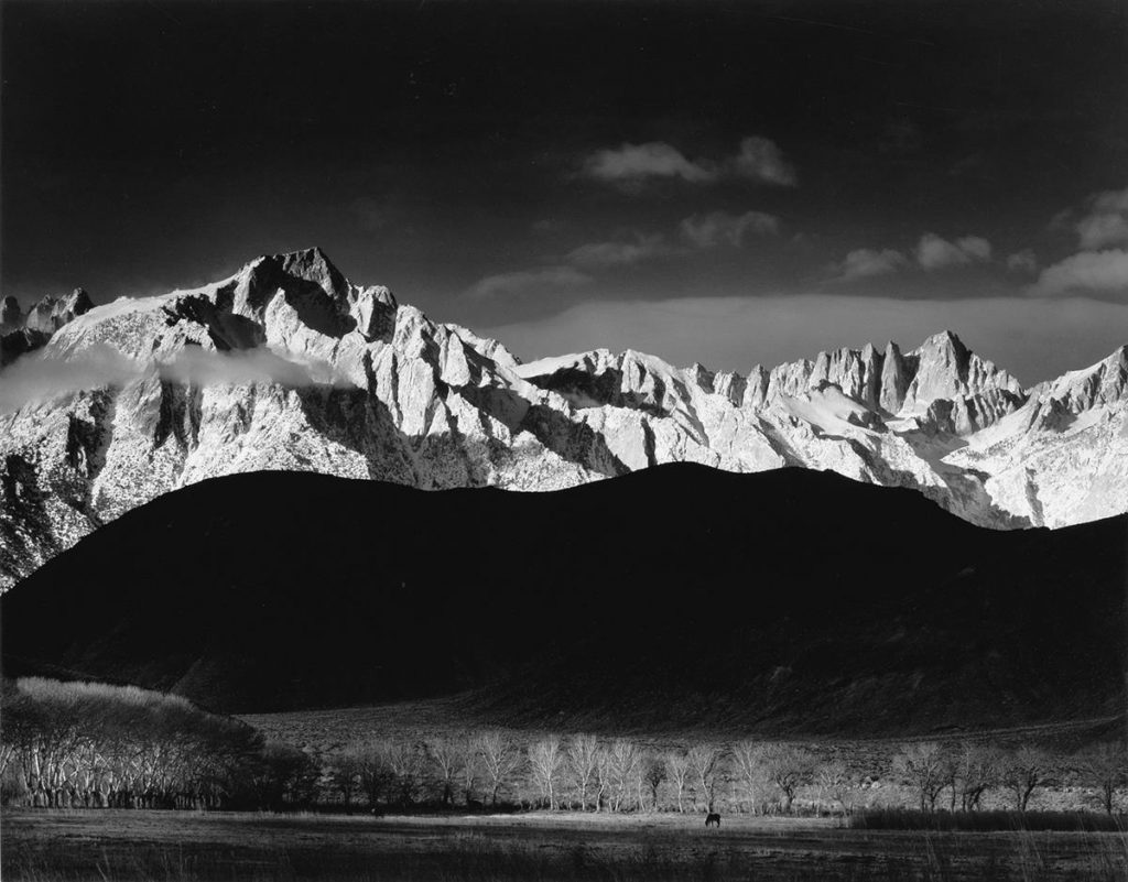 Black and white image of a mountain range by Ansel Adams.