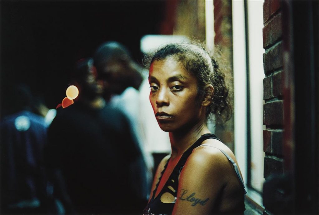 Image of a black woman looking directly at the camera by Khalik Allah.