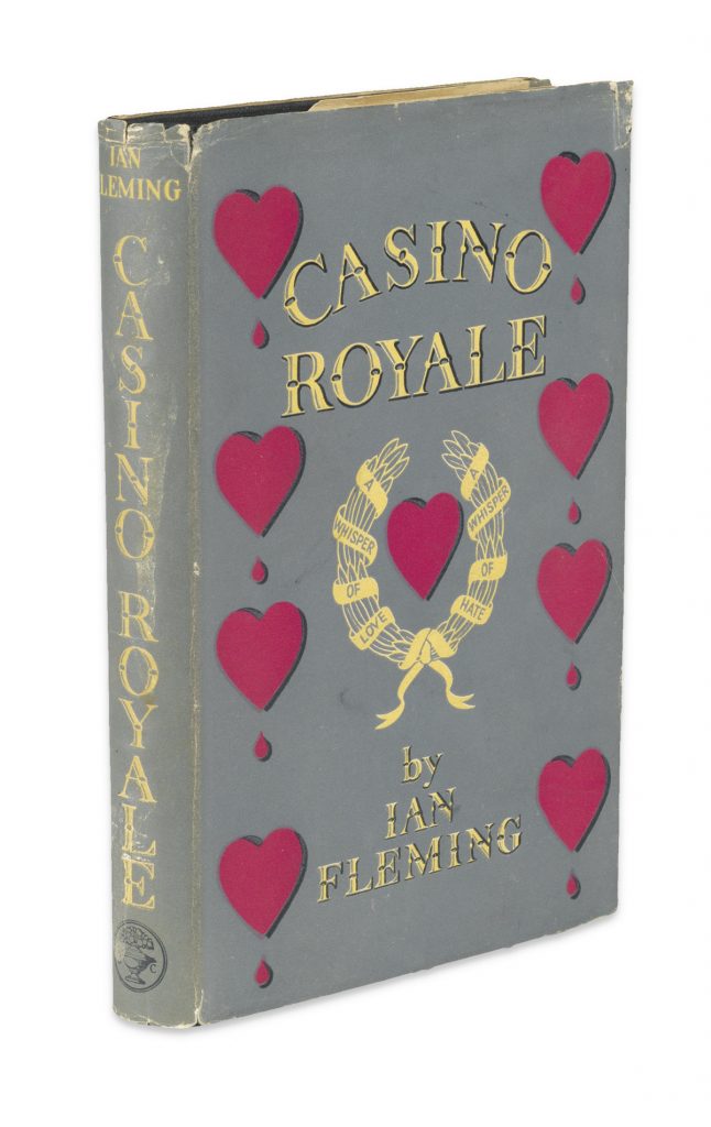 Cover image of Ian Fleming's first James Bond novel, Casino Royale. In dust jacket with a gray background with red hearts down the left and right sides.