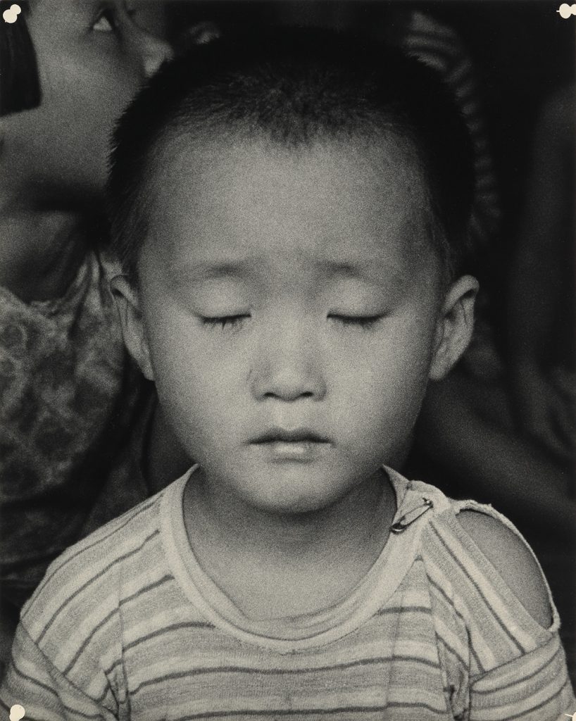 Black and white photograph of a small Korean child by Dorothea Lange