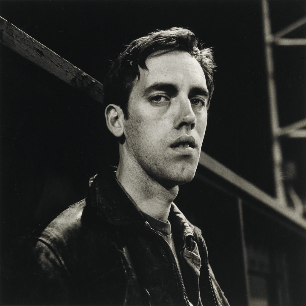 Black and white portrait photograph of David Wojnarowicz by Peter Hujar.