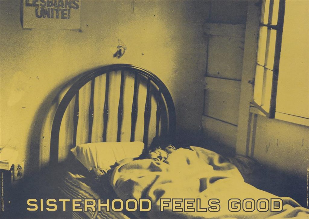 Green tinted poster of a photograph of two women sleeping in bed with the words "Sisterhood Feels Good" along the bottom. By Donna Gottschalk.