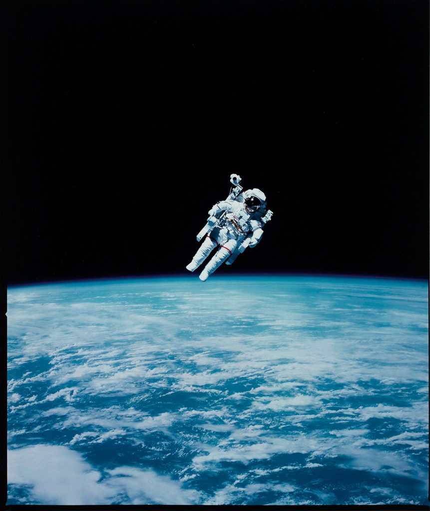 NASA astronaut floating above earth