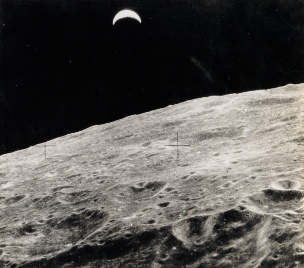 view of the earth from the moon in black and white