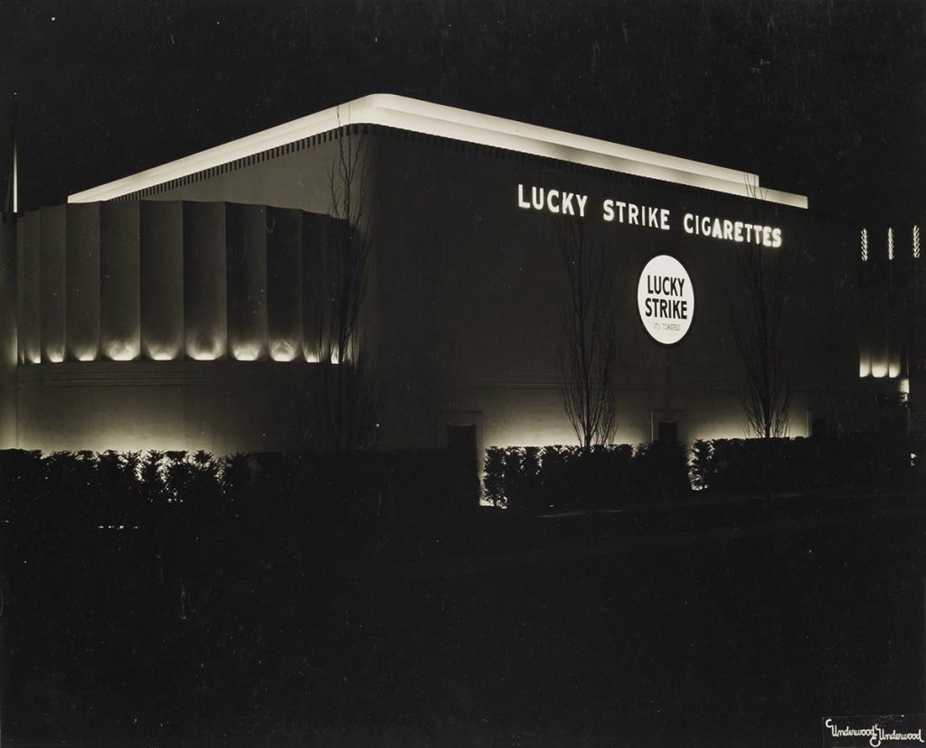 A black and white image of a Lucky Strike Cigarettes factory at night, 1939.
